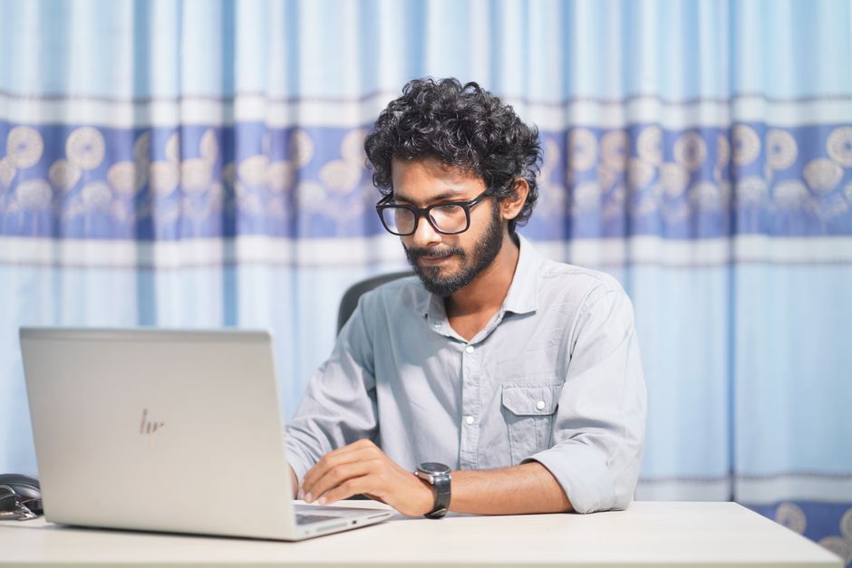 Web designer reviewing a website layout on a laptop